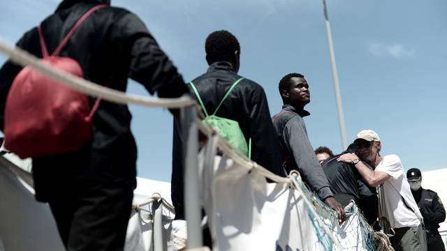 Migrants disembark from the Aquarius rescue ship after arriving to port in Valencia