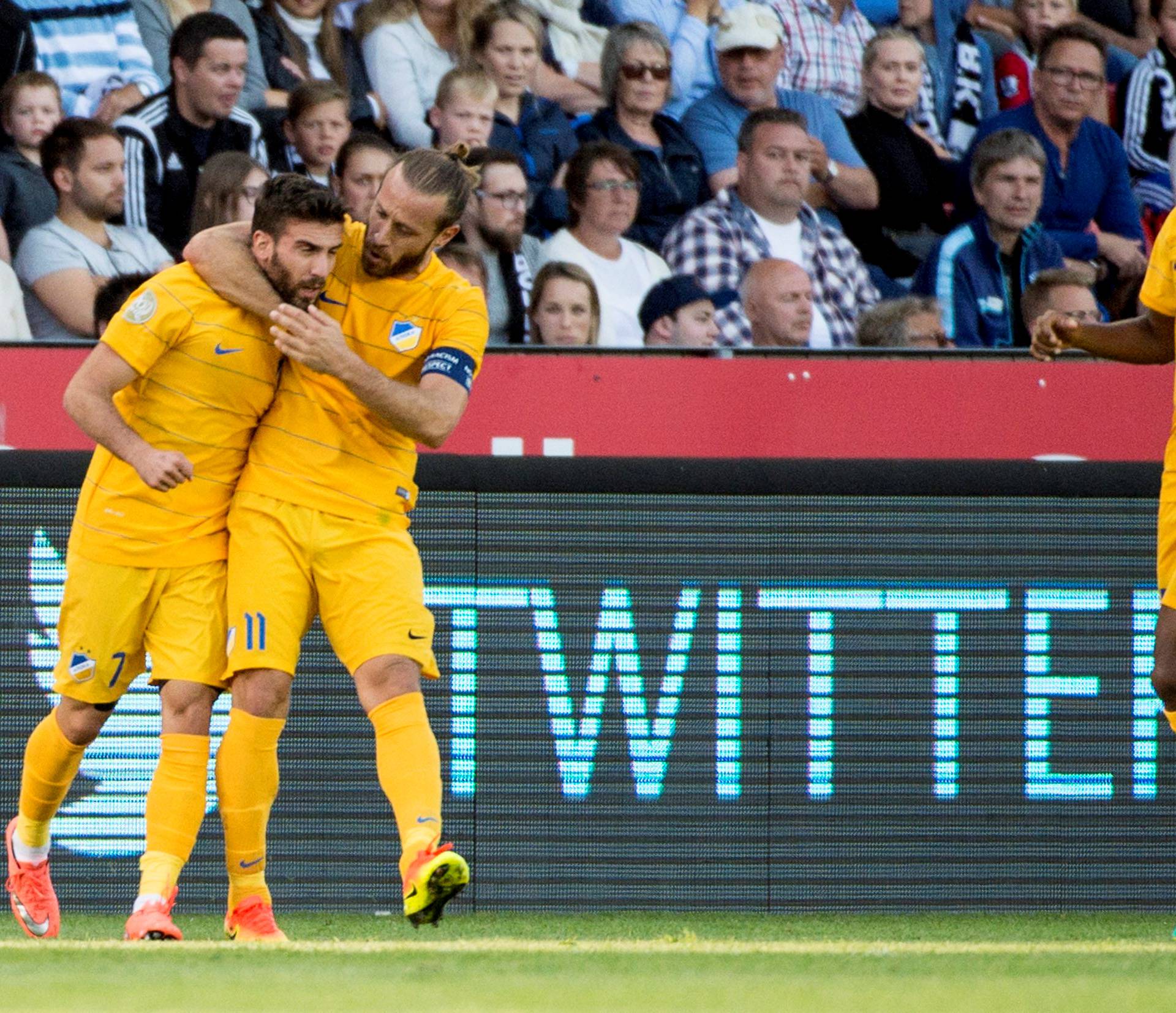 Giorgos Efrem, Nectarios Alexandrou and Carlos Roberto Da Cruz Junior of APOEL celebrate during the UEFA Champions League third qualifying round, first leg soccer match against Rosenborg in Trondheim