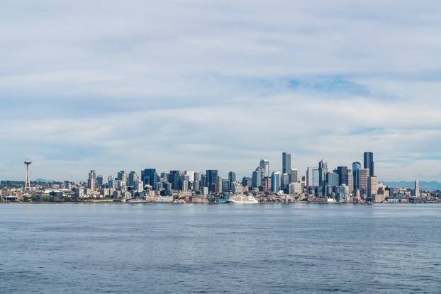 Waterfront Seattle skyline with Great wheel view and iconic observation tower called Space Needle. Skyscrapers of financial downtown at day time, Washington, USA. A vibrant business neighborhood