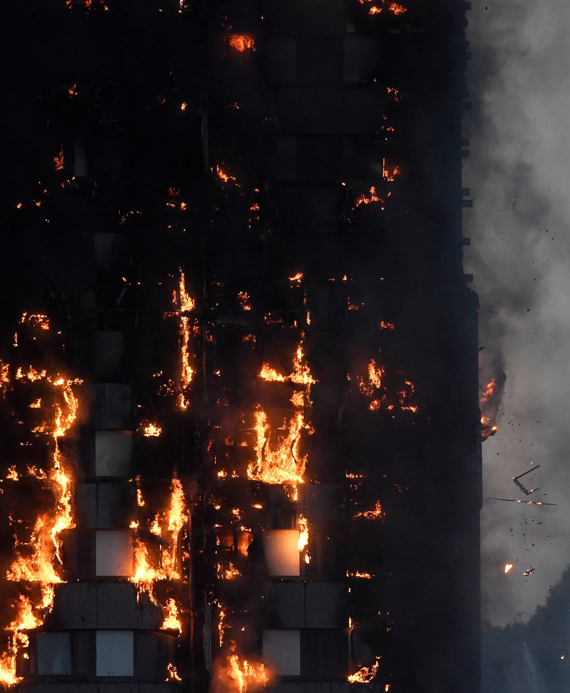 Flames and smoke billow as firefighters deal with a serious fire in a tower block at Latimer Road in West London