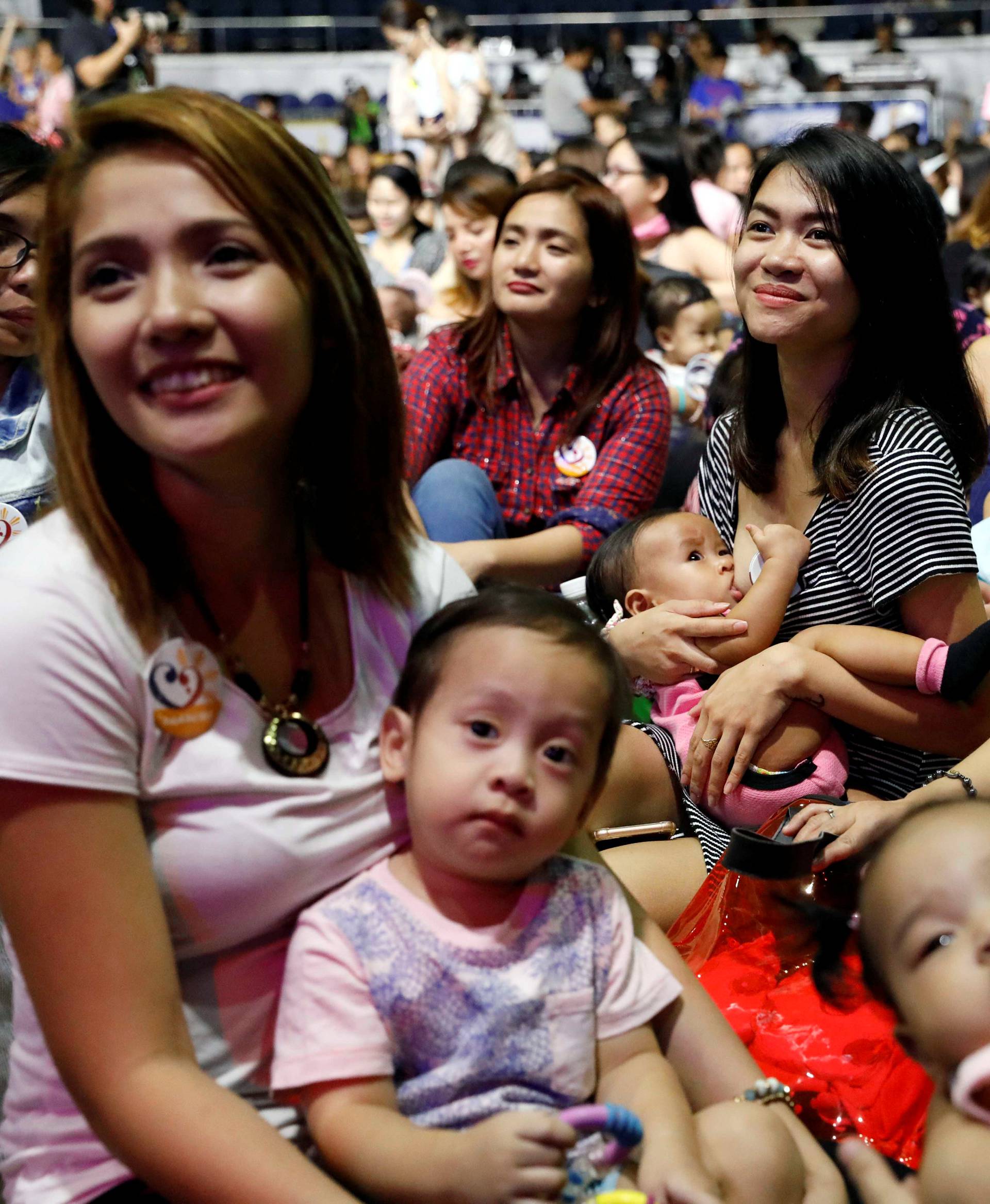 Filipino mothers hold their babies during a one-minute simultaneous breastfeeding event, as a way to promote breastfeeding, on the sidelines of this year's ASEAN foreign ministers summit, in Manila