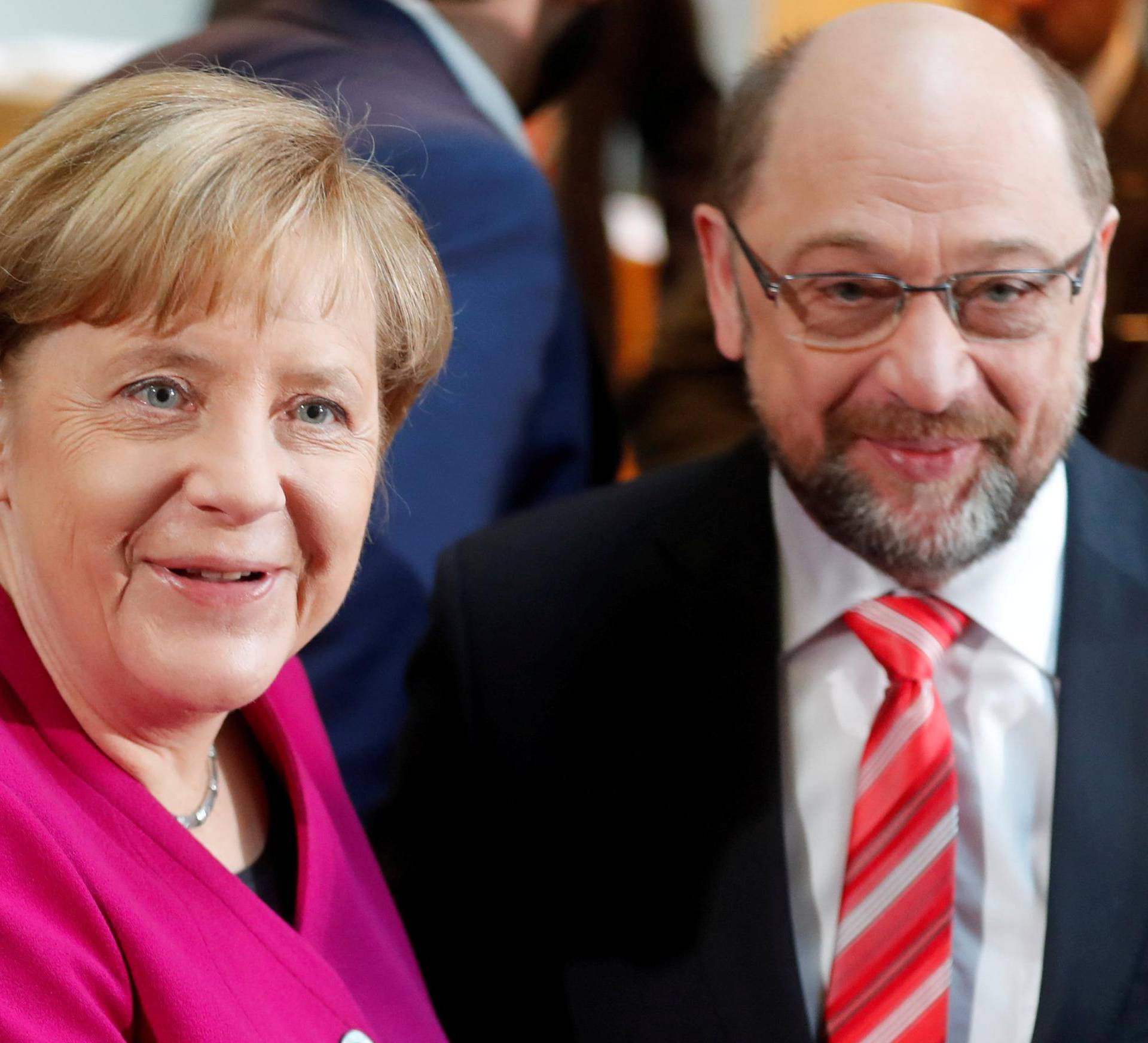 CDU leader and acting German Chancellor Merkel and SPD leader Schulz shake hands a speech before exploratory talks about forming a new coalition government at the SPD headquarters in Berlin