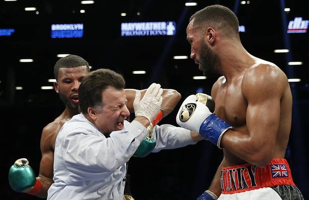 Referee Arthur Mercante Jr is hit by Badou Jack as James DeGale looks on