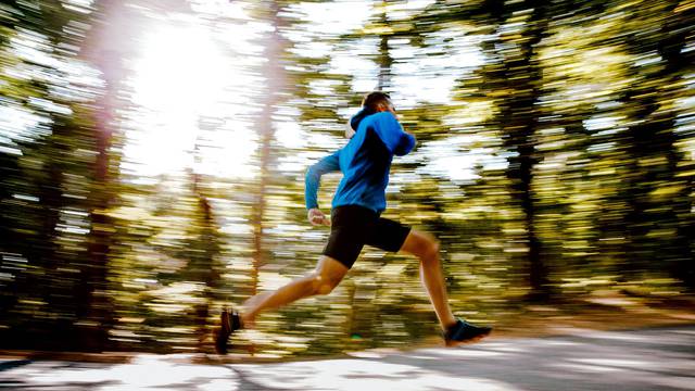 blurred motion male athlete runner