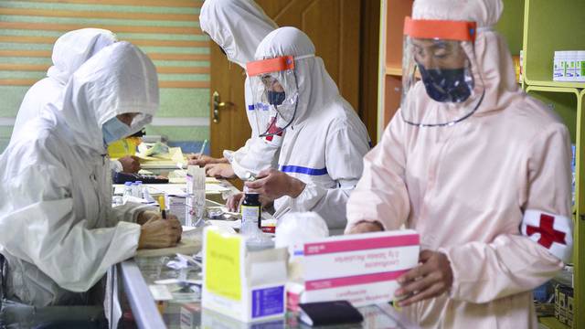 FILE PHOTO: Members of North Korean army supply medicines to residents at pharmacy amid fears over COVID-19, in Pyongyang