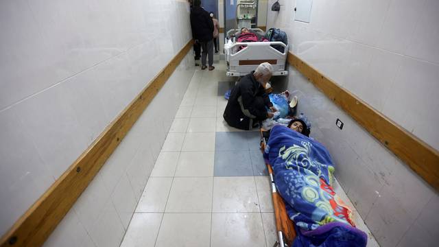 Palestinians wounded in an Israeli strike lie in corridor at Nasser hospital in Khan Younis