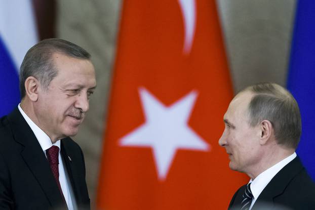 Russian President Putin shakes hands with his Turkish counterpart Erdogan after the talks in Moscow