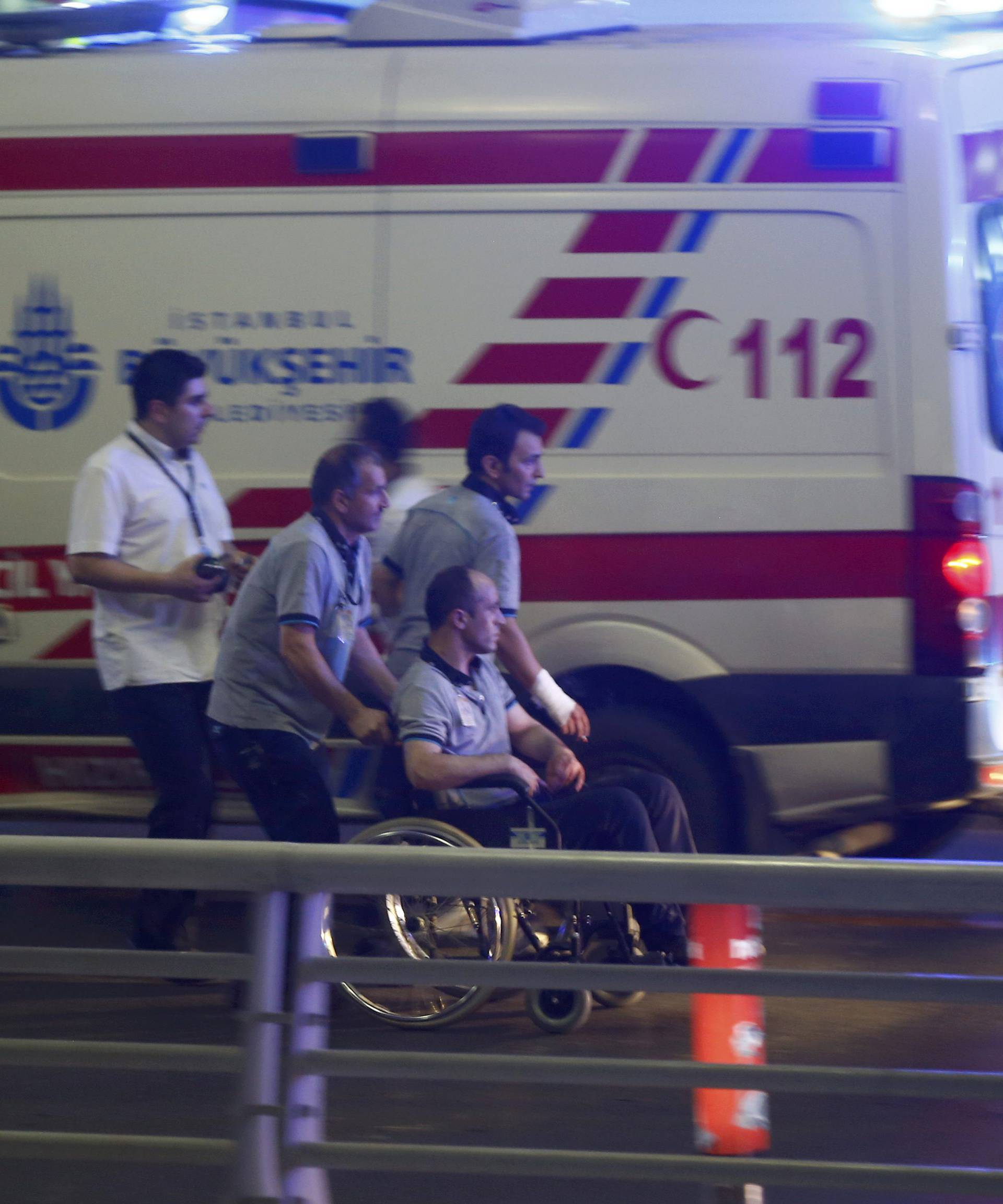 Paramedics help a man in a wheelchair at Turkey's largest airport