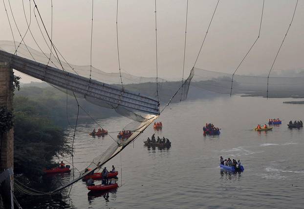 Rescuers search for survivors after a suspension bridge collapsed in Morbi town
