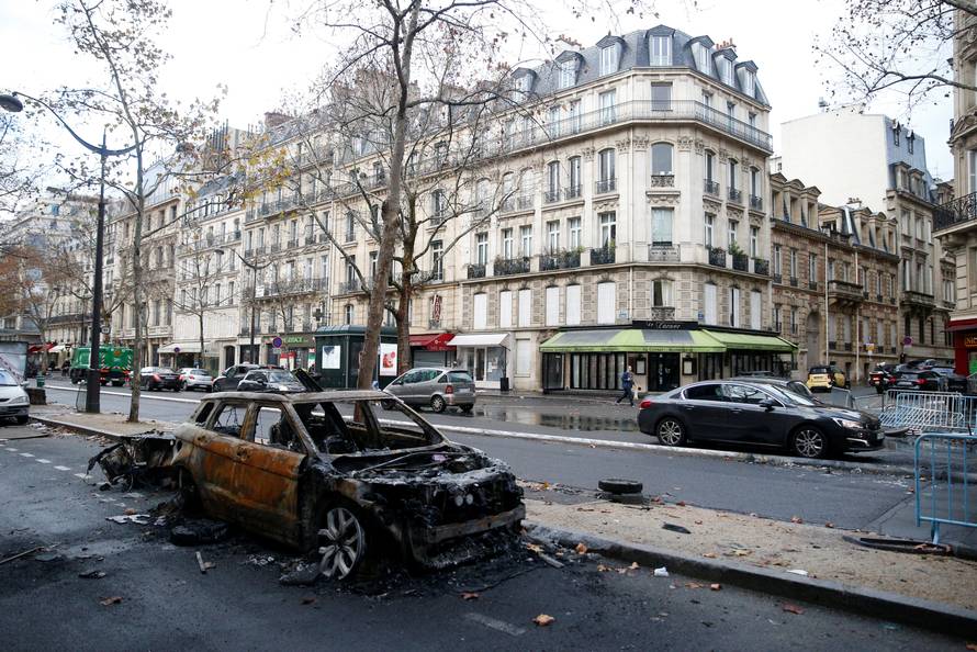 A vandalized car is seen the morning after clashes with protesters wearing yellow vests, a symbol of a French drivers' protest against higher diesel taxes, in Paris