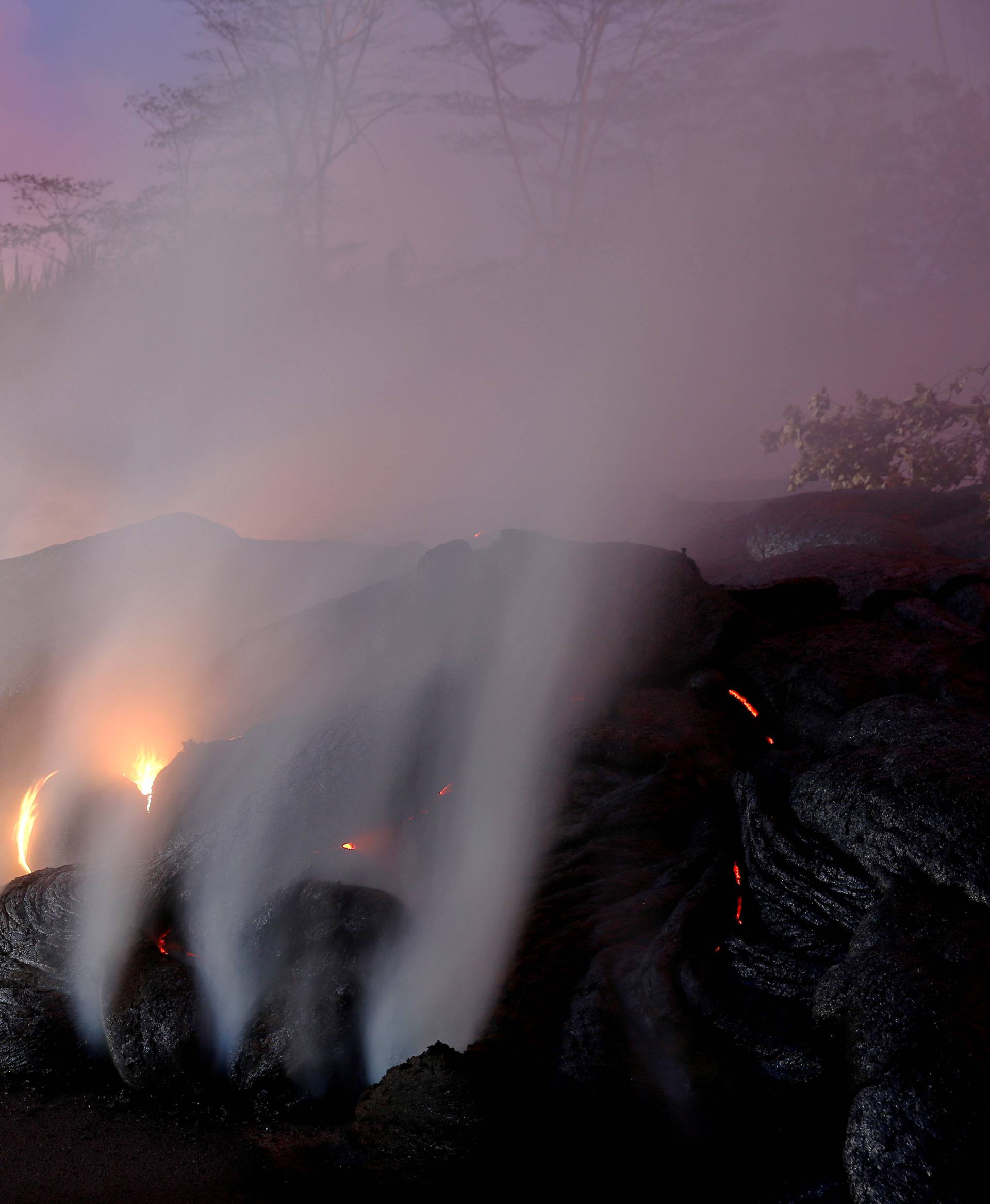 Volcanic gases rise from the Kilauea lava flow that crossed Pohoiki Road near Highway 132, near Pahoa, Hawaii