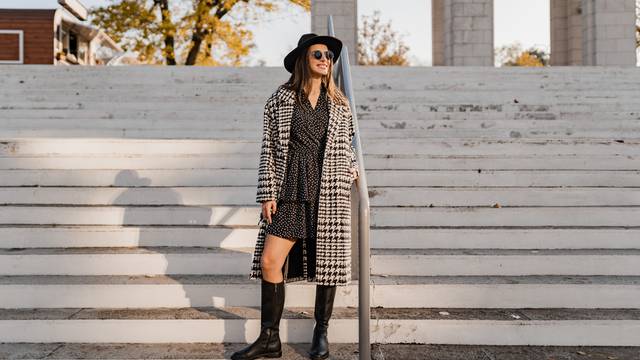 attractive young woman walking in autumn wearing coat