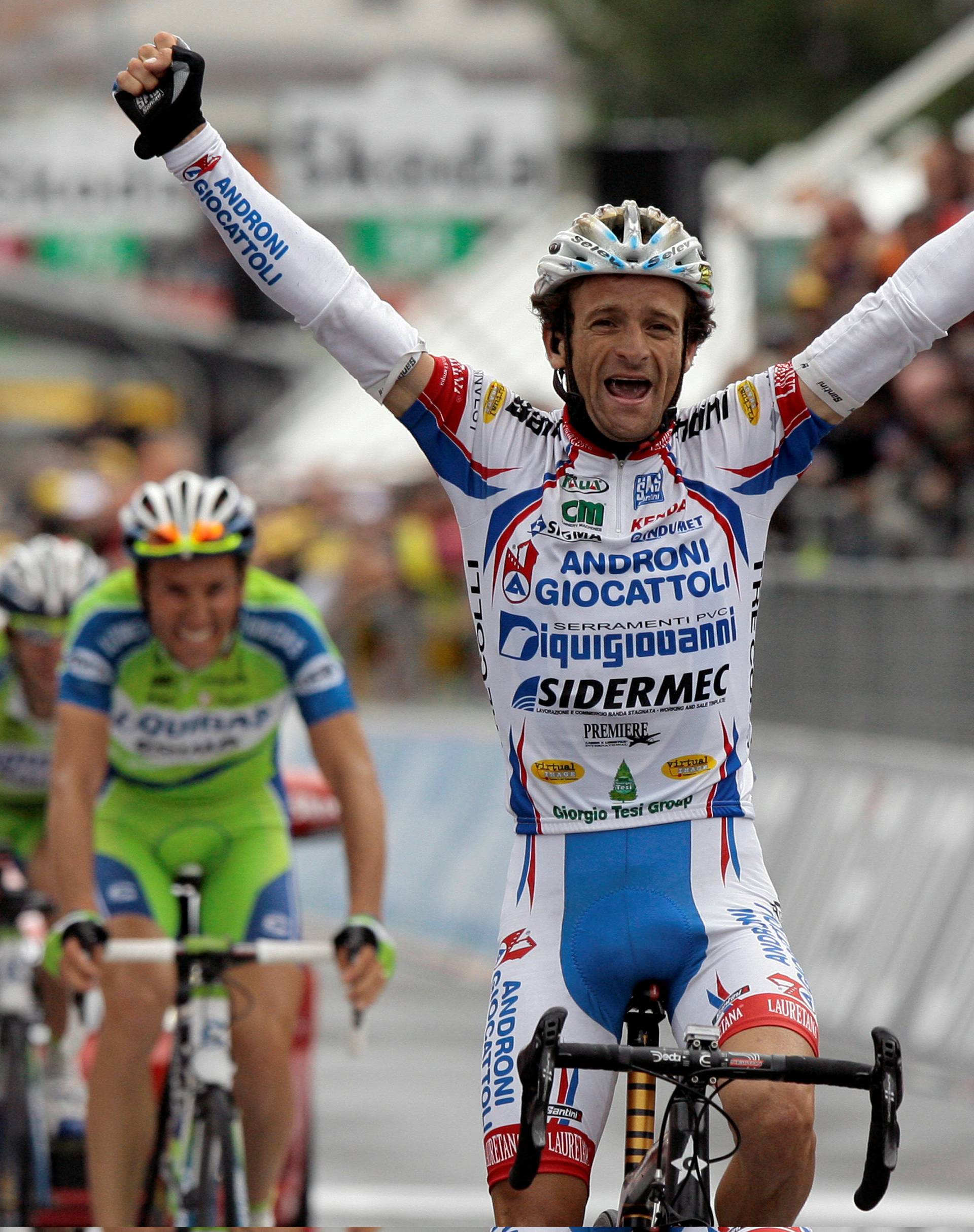FILE PHOTO: Androni-Diquigiova team rider Scarponi celebrates winning the 19th stage of the Giro d'Italia cycling race