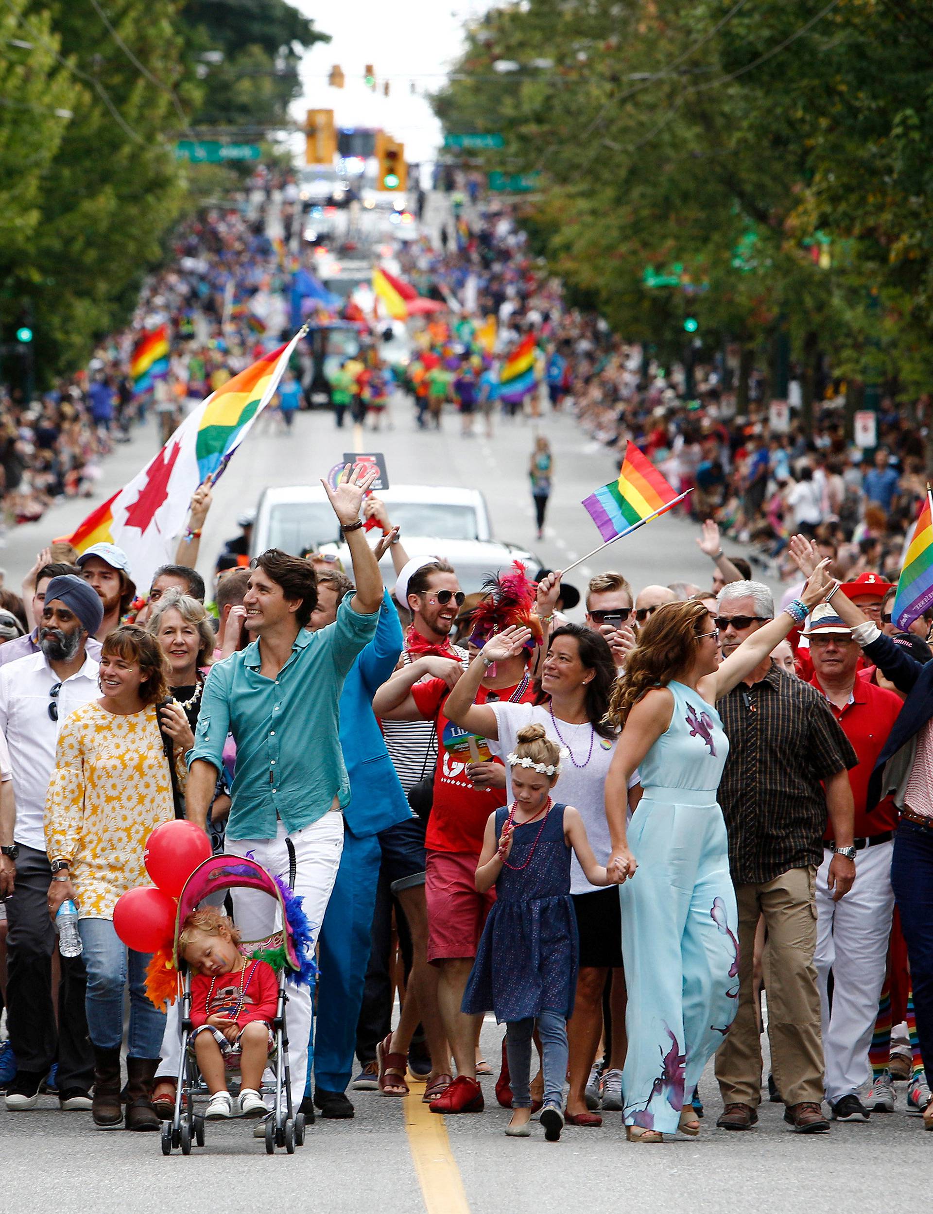 Canada's Prime Minister Justin Trudeau waves to the crowd while walking in the Vancouver Pride Parade with his family in Vancouver