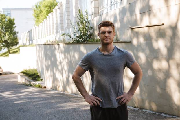 Confident sportsman standing in shorts