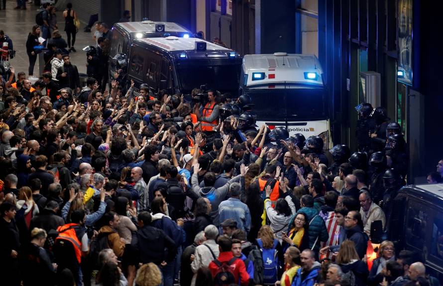 People participate in a protest outside the Sants train station in Barcelona