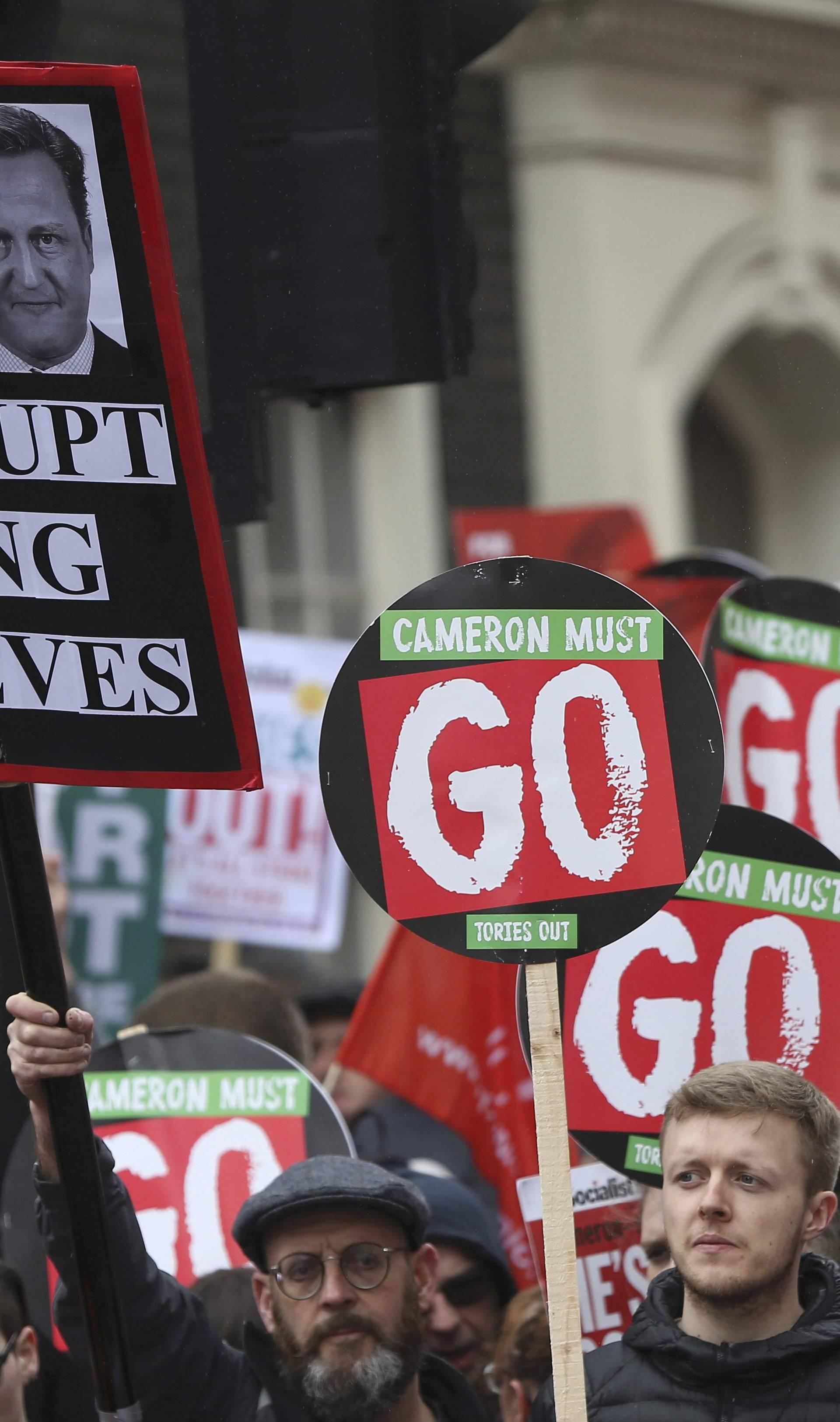 Demonstrators hold placards during an anti-austerity protest in London