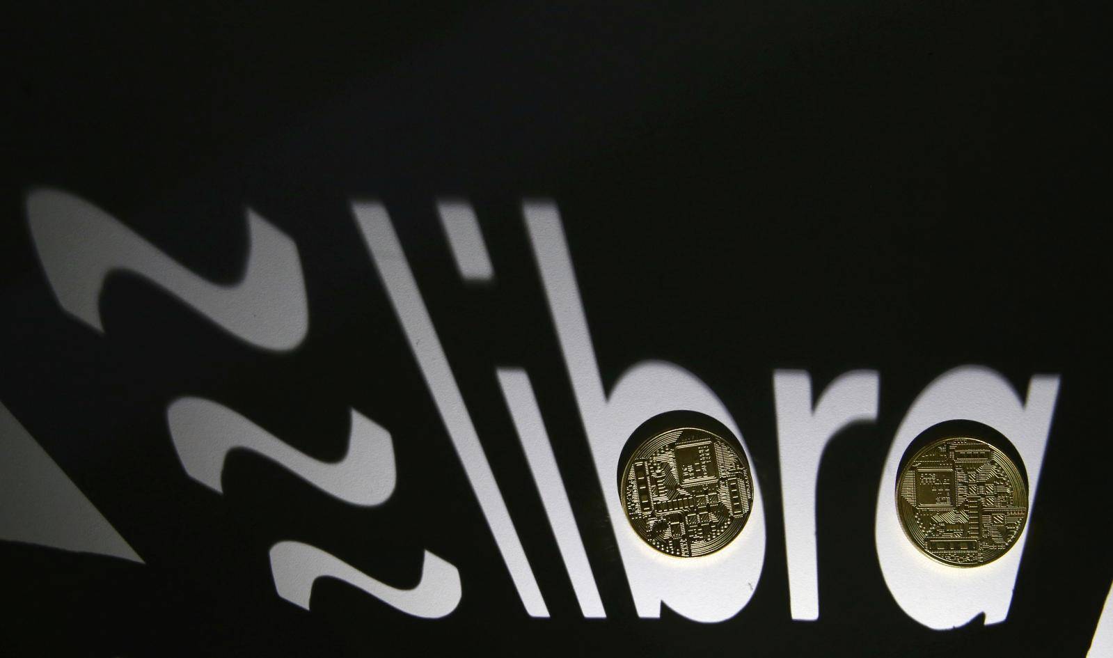 FILE PHOTO: FILE PHOTO: Shadow of a 3D-printed Facebook Libra cryptocurrency logo is seen near cryptocurrency representation in this illustration taken
