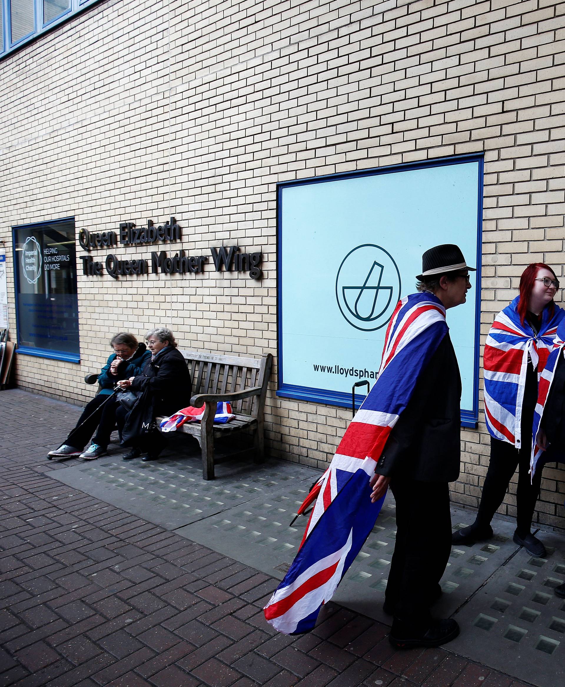 Fans of Britain's royal family stand outside the hospital where Catherine, the Duchess of Cambridge, is due to give birth, in London