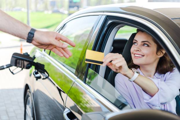 Selective,Focus,Of,Happy,Woman,Sitting,In,Car,And,Giving