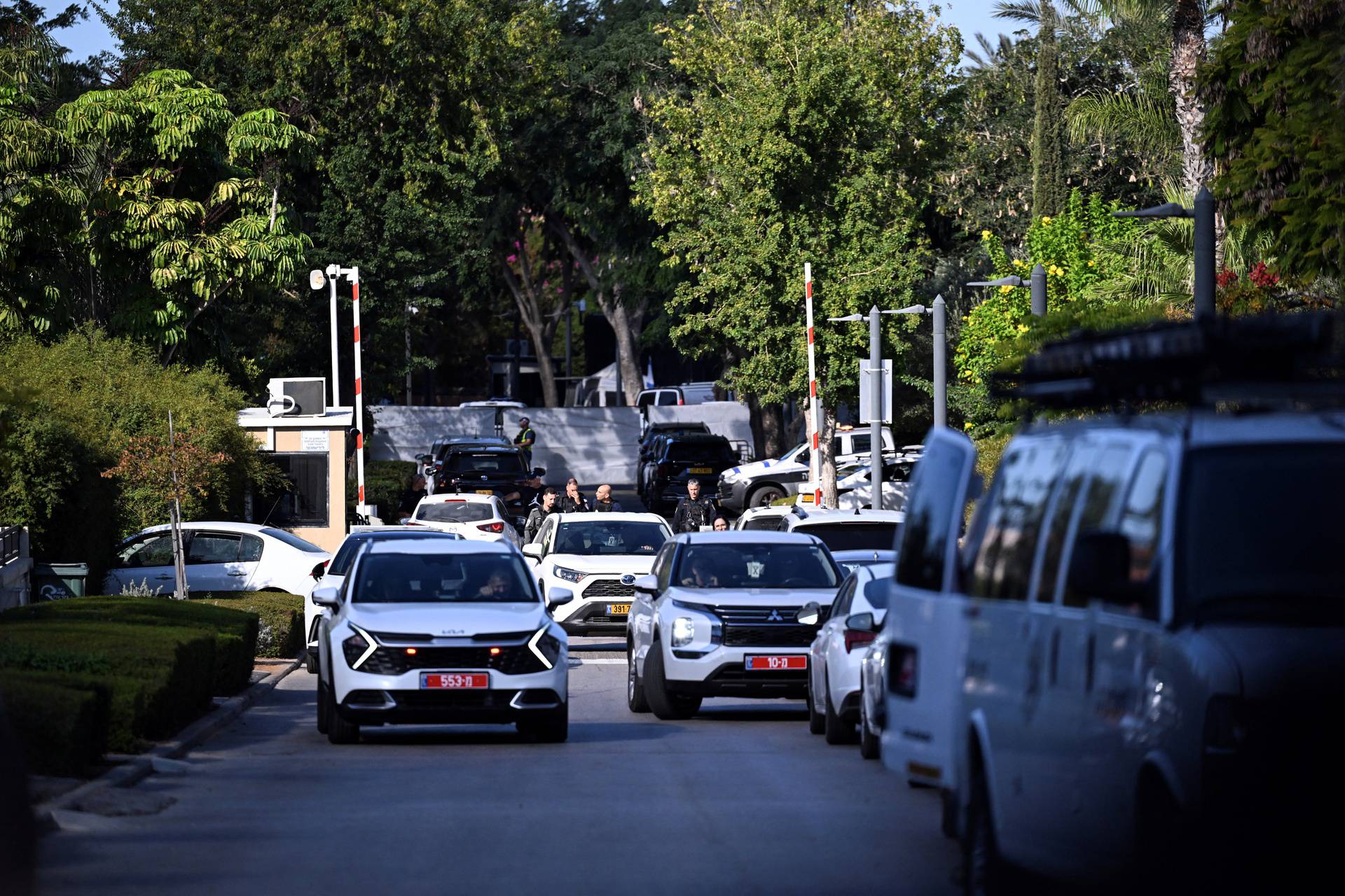 Member of Israeli security personnel stands at a street in Caesarea, following drone attack from Lebanon