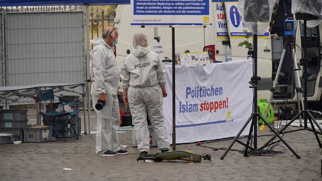 FILE PHOTO: Police investigators work at the scene where a man attacked people at a far right-wing information stand of the Buergerbewegung Pax Europa in Mannheim