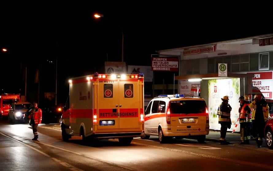 German emergency services workers work in the area where a man with an axe attacked passengers on a train near Wuerzburg
