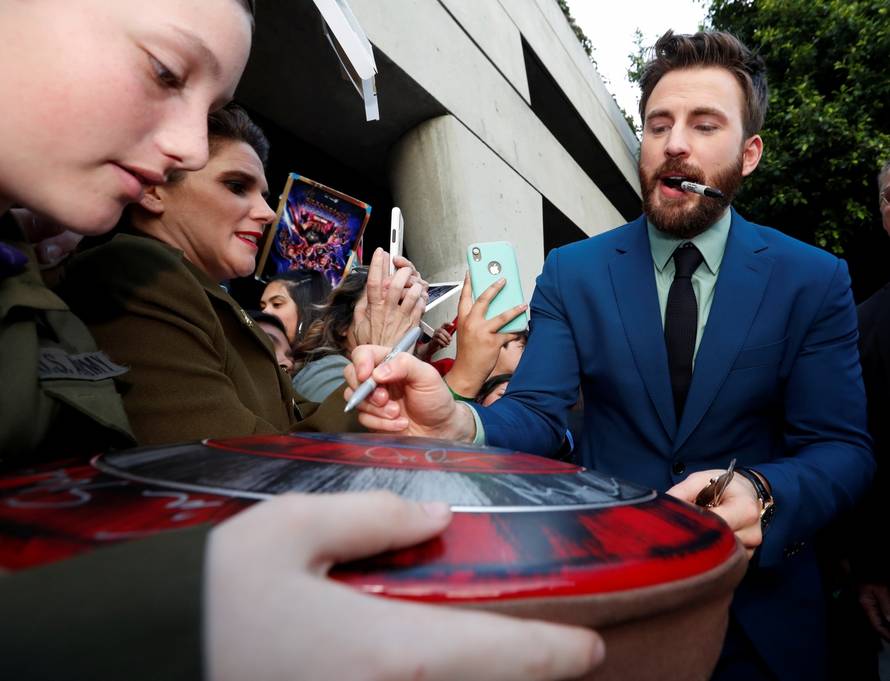 Cast member Chris Evans signs autographs for fans on the red carpet at the world premiere of the film "The Avengers: Endgame" in Los Angeles