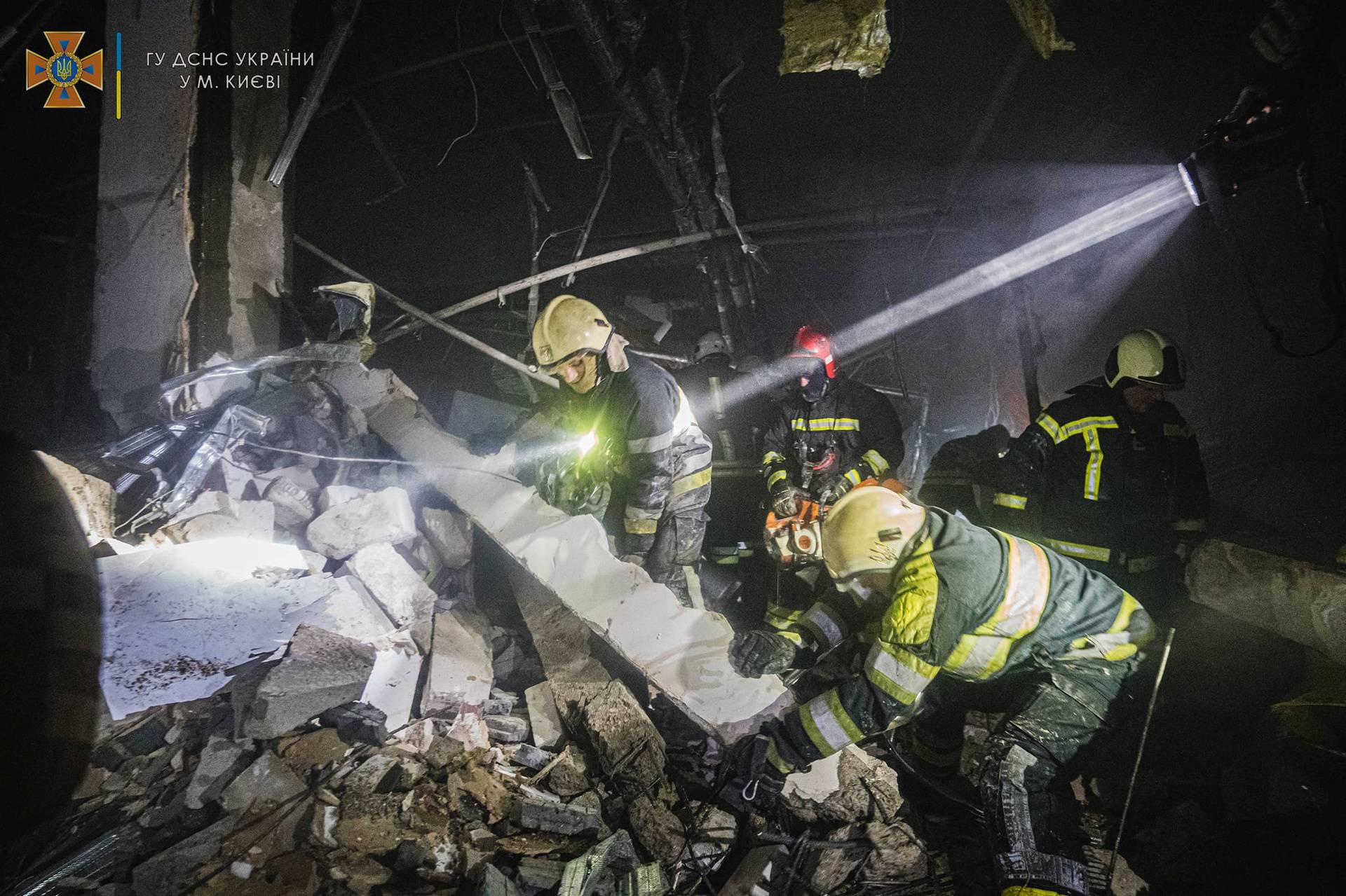 Rescuers work at the site of a shopping mall damaged by an airstrike in Kyiv