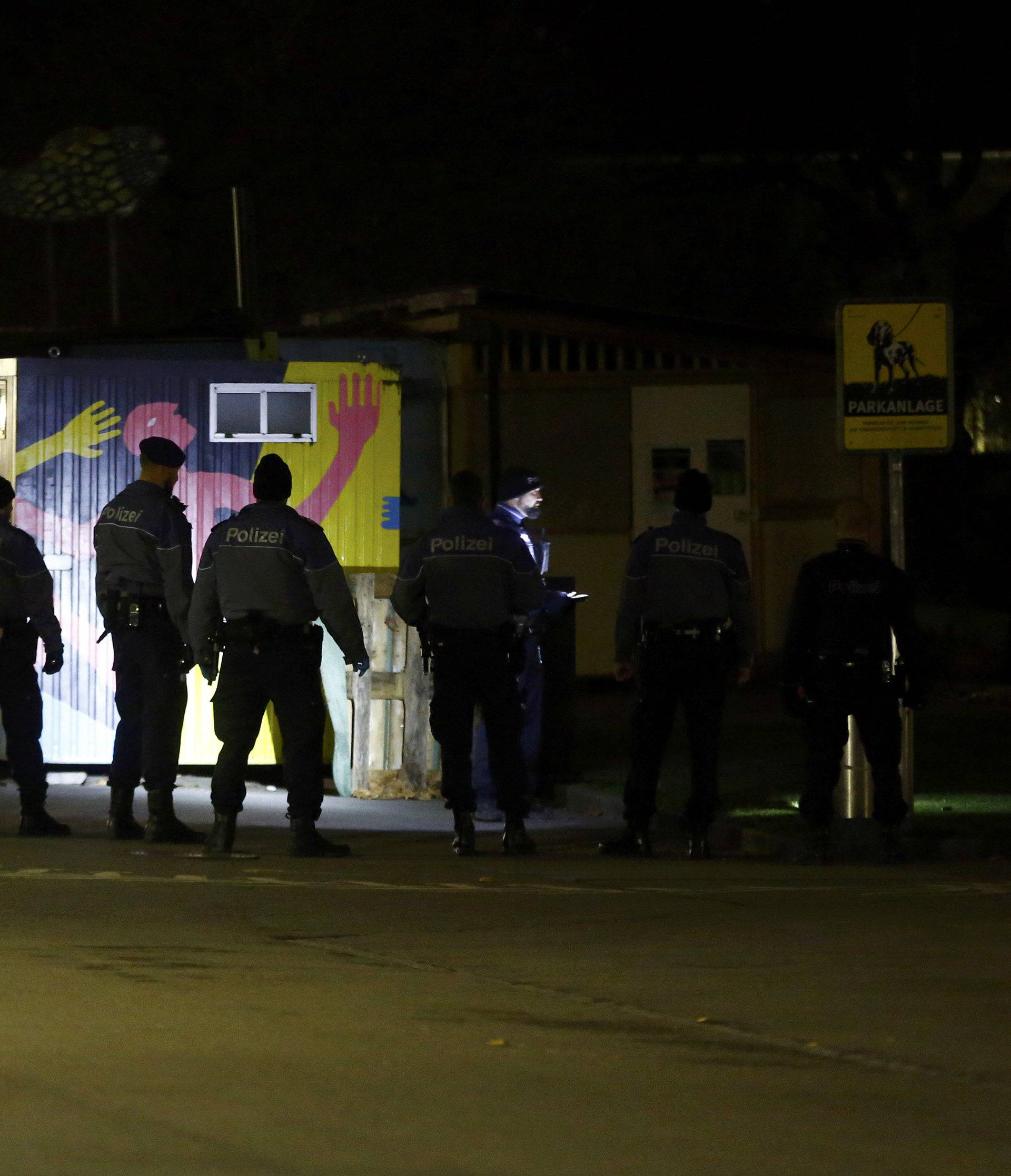 Police stand outside an Islamic center in central Zurich