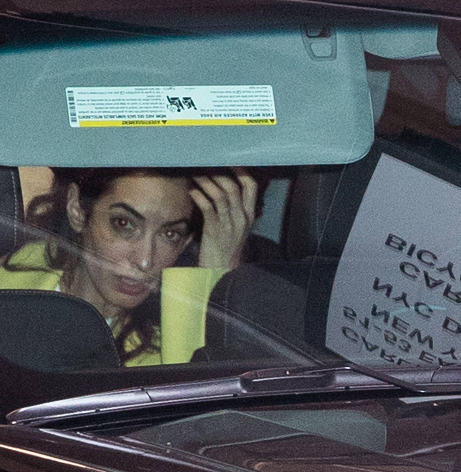 George CLooney and Amal Clooney put their kids into the SUV in the garage at a hotel in New York