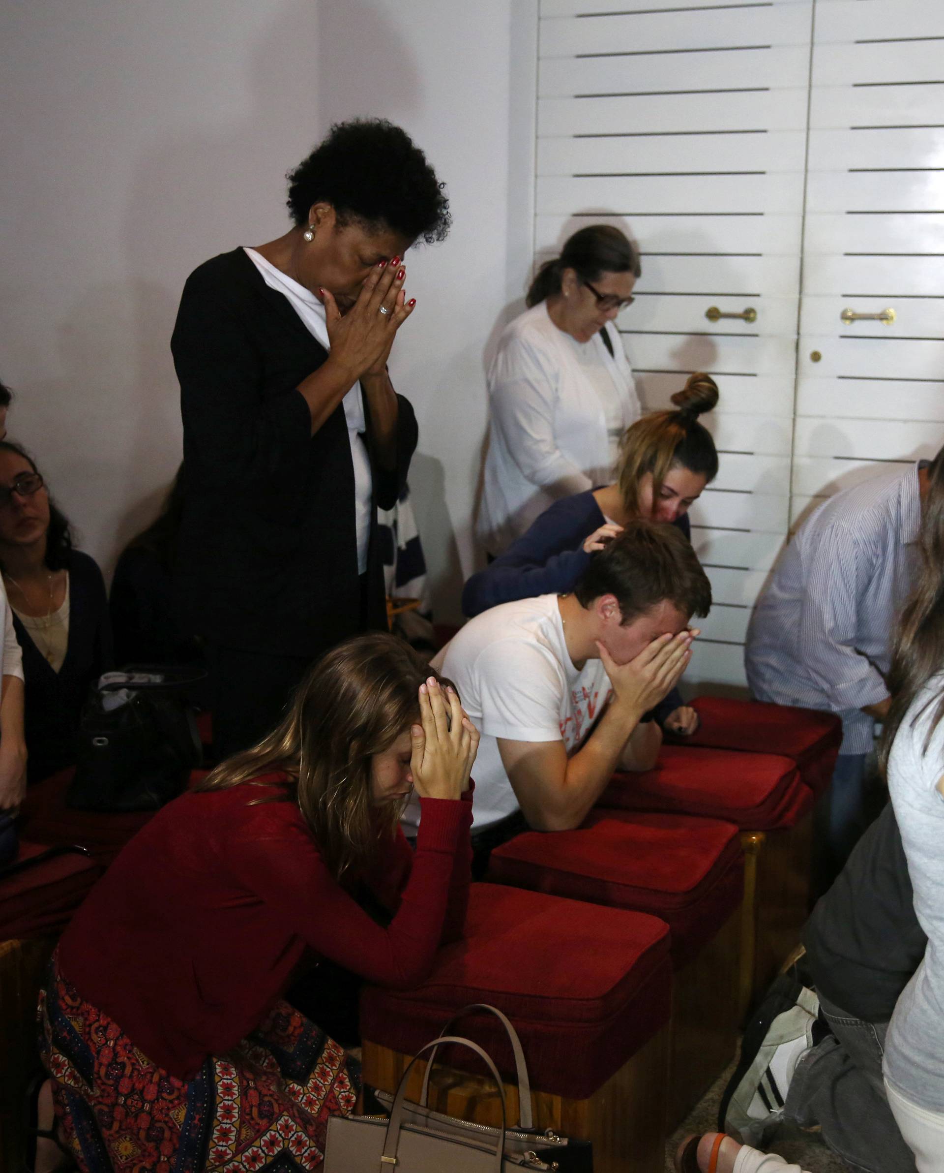 Relatives of Brazilian journalist Guilherme Marques mourn during a mass in Rio de Janeiro