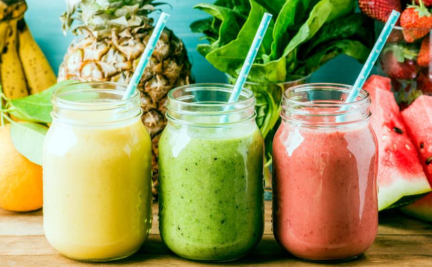 Freshly blended fruit smoothies of various colors and tastes