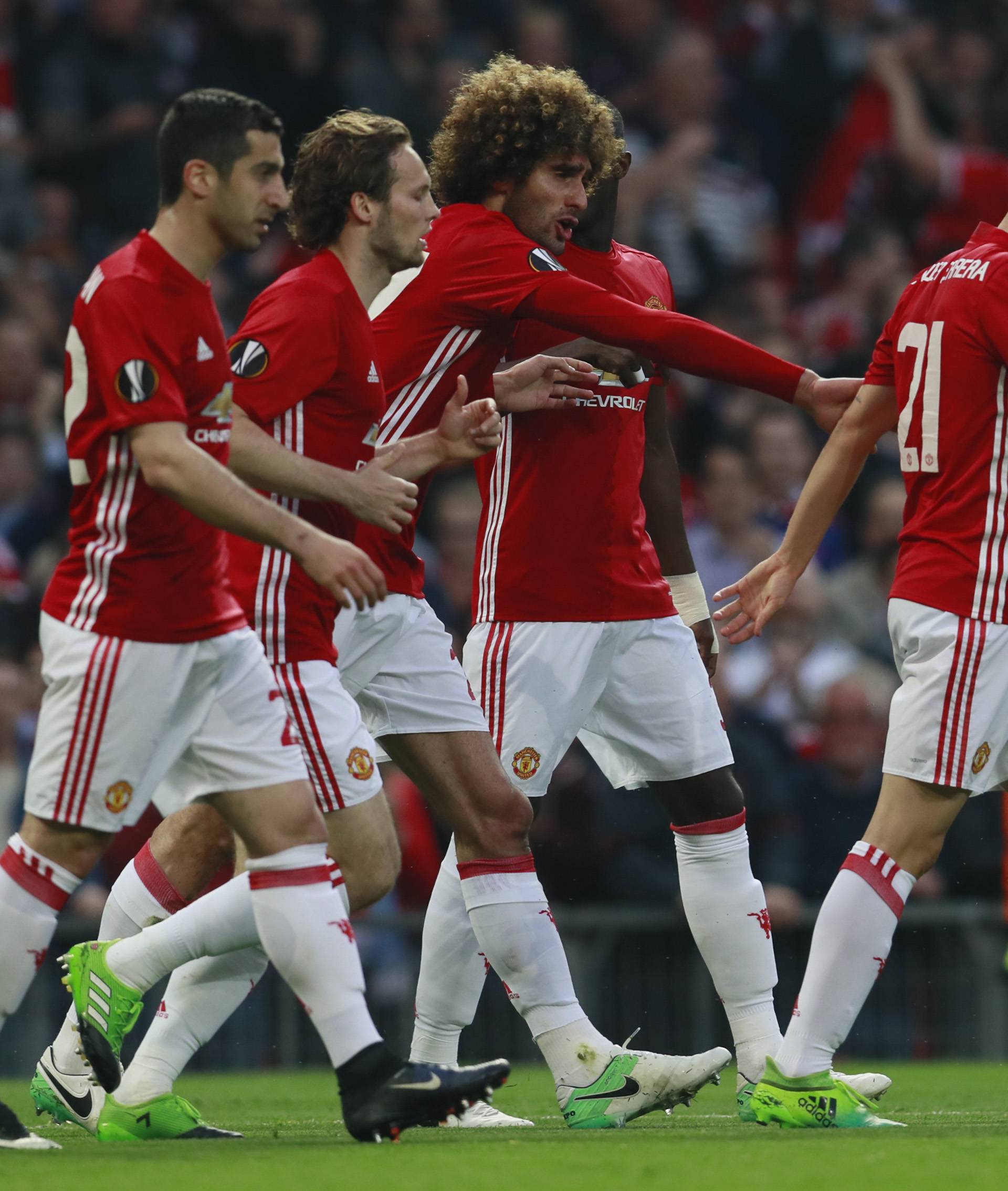 Manchester United's Marouane Fellaini celebrates scoring their first goal with teammates