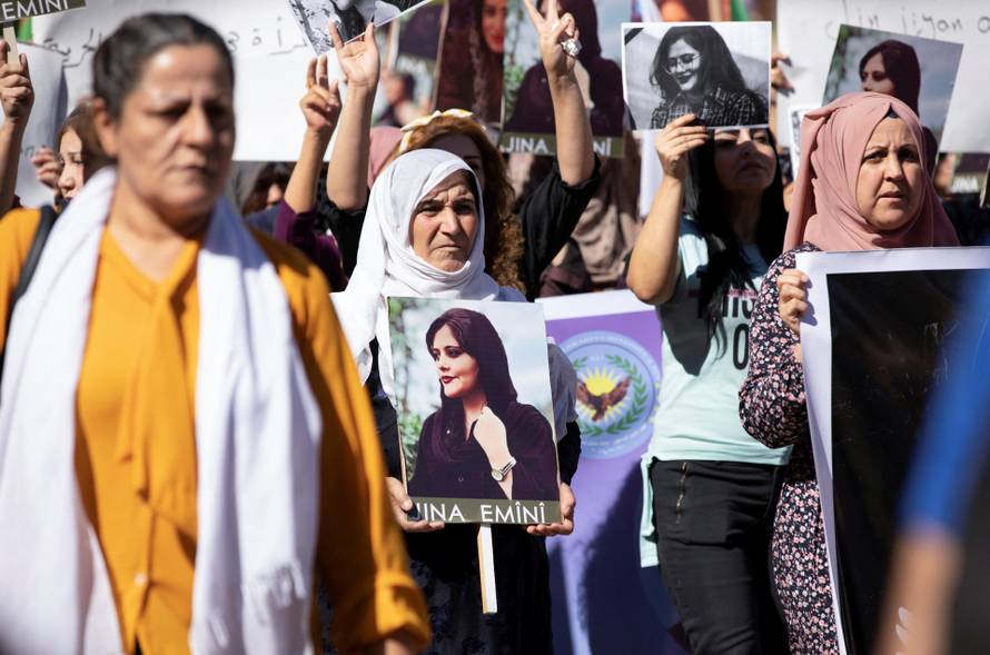 Women protest over the death of Mahsa Amini in Iran, in the Kurdish-controlled city of Qamishli