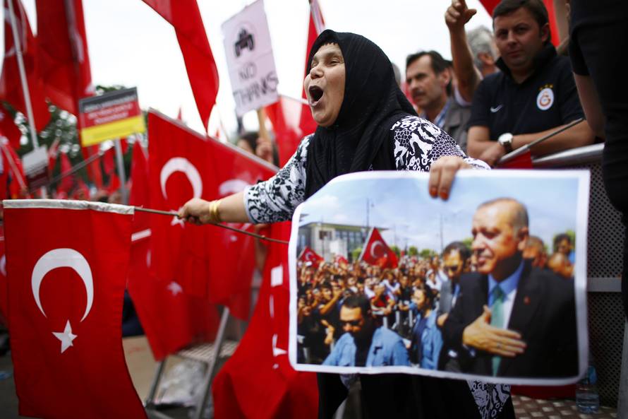 Supporters of Turkish President Erdogan wave Turkish flags during a pro-government protest in Cologne