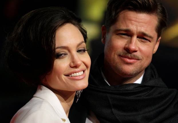 U.S. actor Pitt and his partner Jolie pose for photographers on the red carpet in Berlin