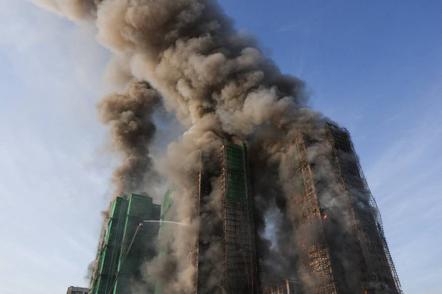 Flames engulf bamboo scaffolding across multiple buildings at Wang Fuk Court housing estate, in Tai Po