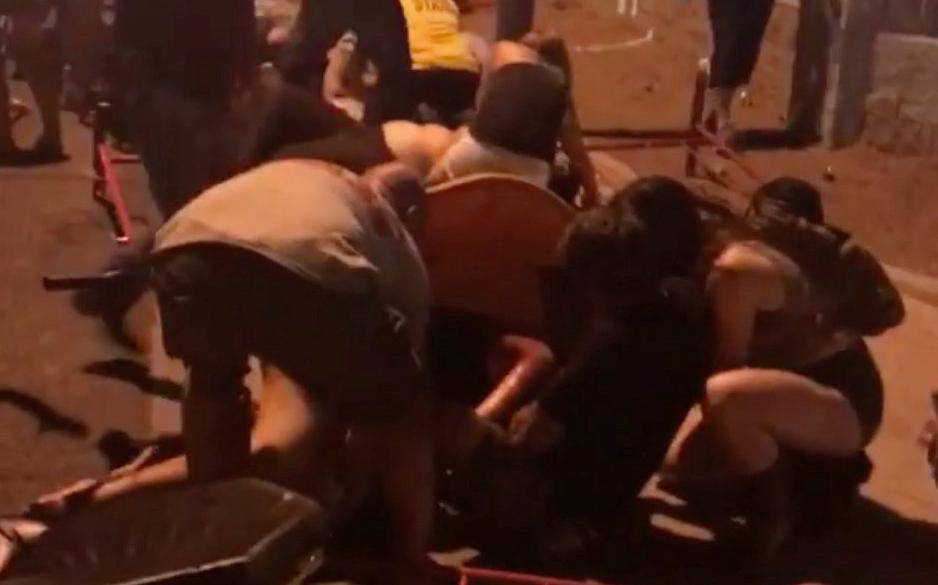 People provide help after a gunman opened fire on attendees of the Route 91 Harvest Music Festival in Las Vegas