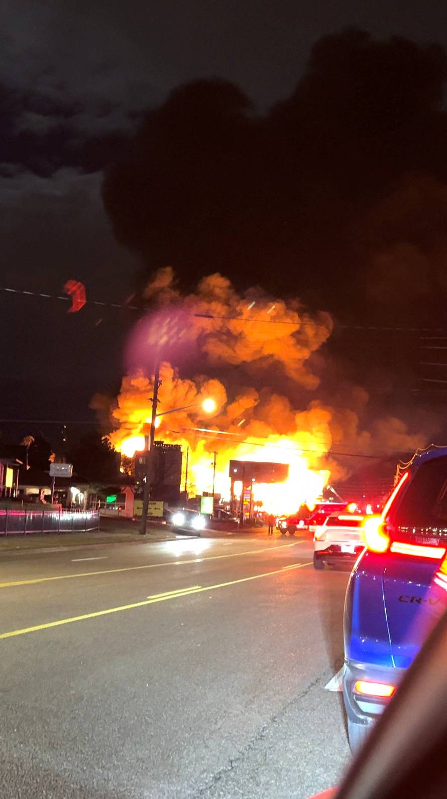Smoke and flames rise from the site of a burning building, in Denver