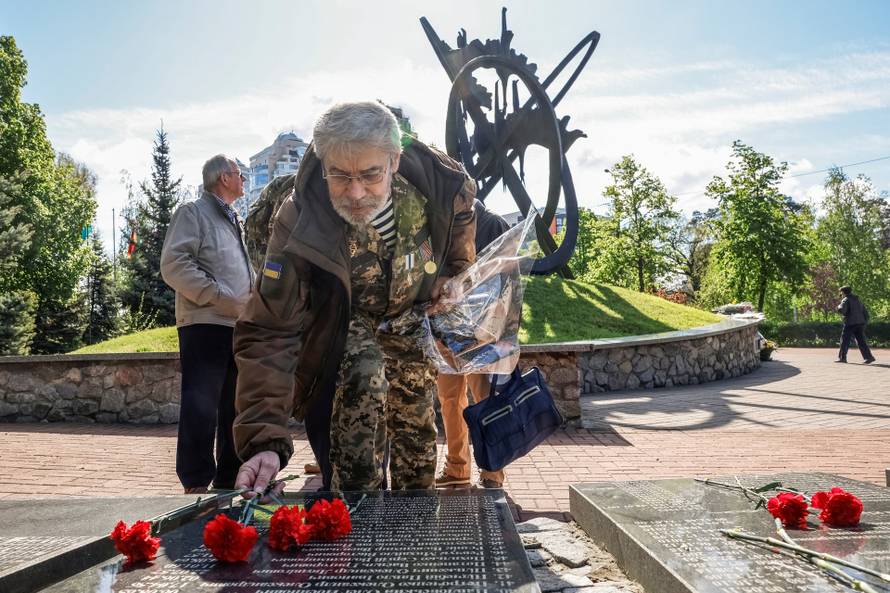People attend a ceremony marking the anniversary of the Chornobyl nuclear disaster in Kyiv