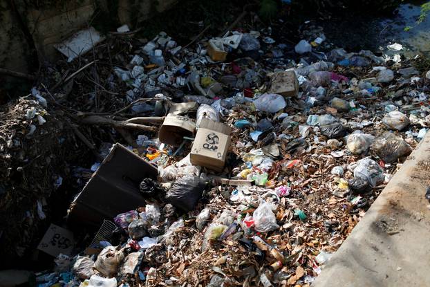 A CLAP box, a Venezuelan government handout of basic food supplies, is seen amid garbage dump along a canal in Maracaibo