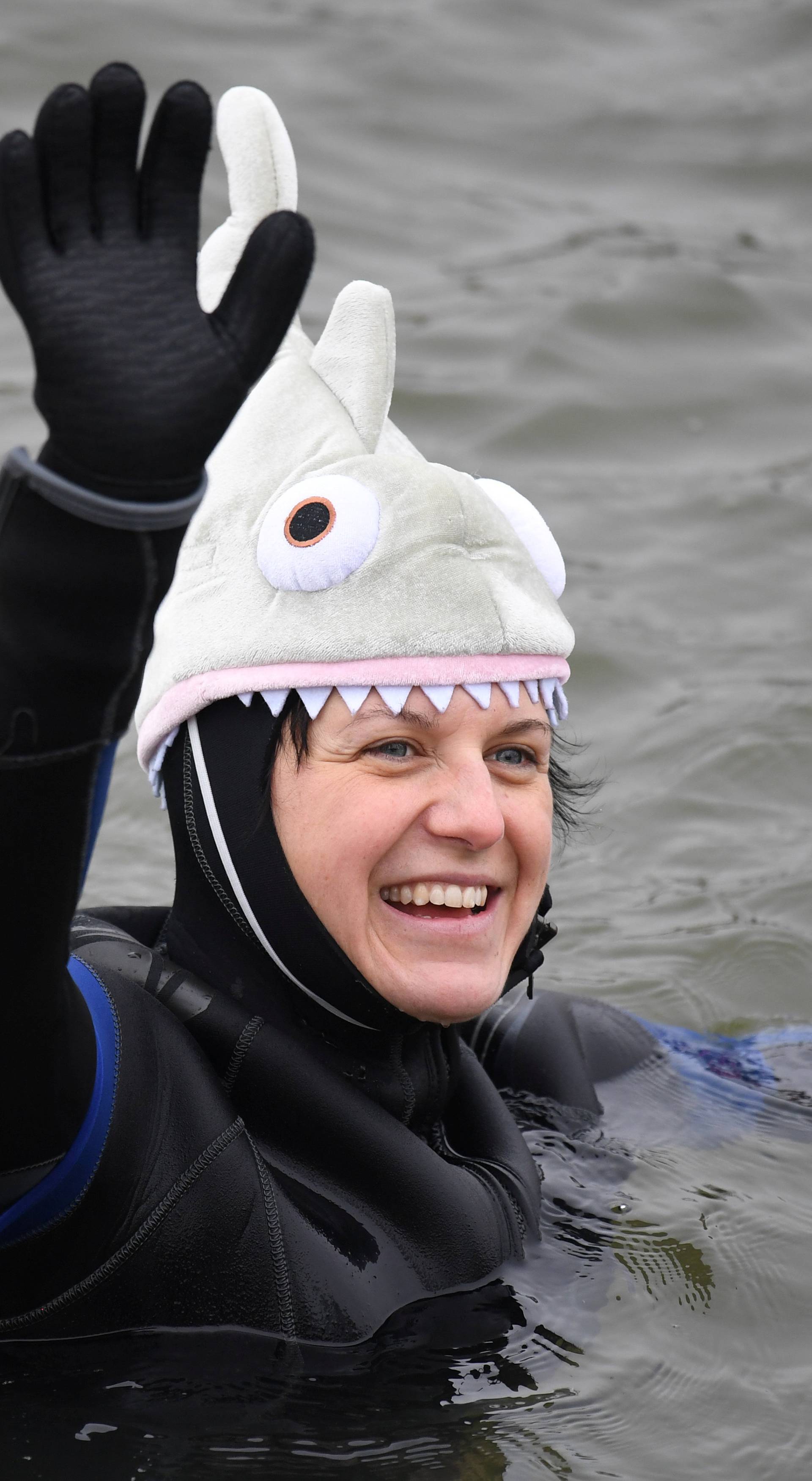 A swimmer wearing a costume bathes in the 3 degrees Celsius water of the river Danube in Neuburg an der Donau