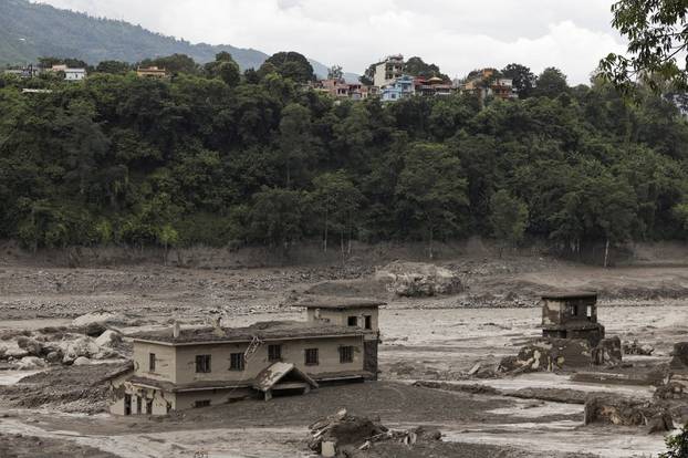 Mud covers a property following a flash flood at Trishuli, Nepal