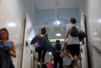 People enter the Miquel Tarradell high school, one of the designated polling stations, after students left for the day to occupy the premises in a bid to permit voting in the banned independence referendum in Barcelona