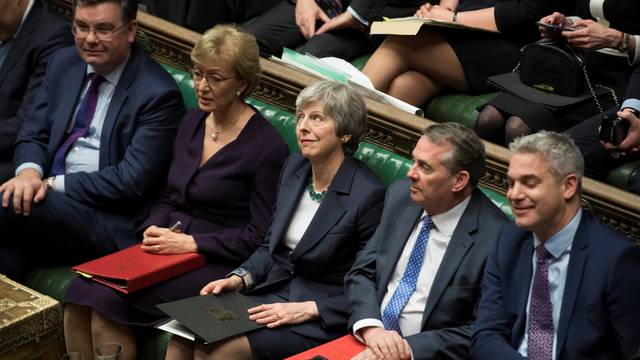 Britain's Prime Minister Theresa May reacts in Parliament following the vote on Brexit in London