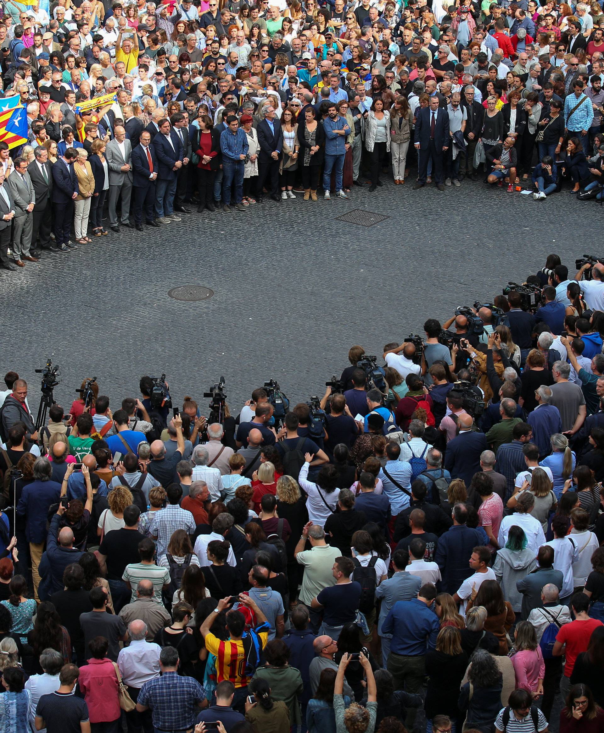 Catalan regional government members and local politicians stand in Plaza Sant Jaume as they join a protest called by pro-independence groups for citizens to gather at noon in front of city halls throughout Catalonia, in Barcelona
