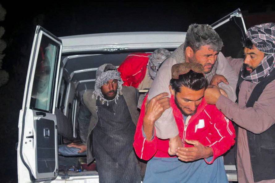 A man is carried out of a vehicle following an earthquake at an unidentified location in Afghanistan