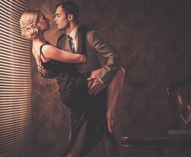 Couple in retro interior near a window