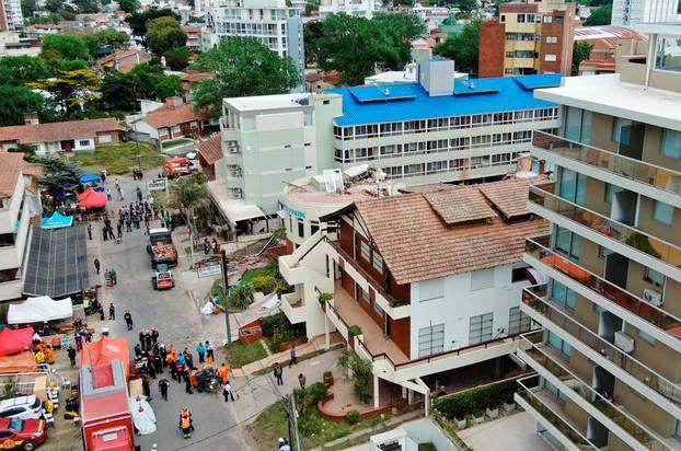 Firefighters search for trapped people after a hotel collapses in Villa Gesell